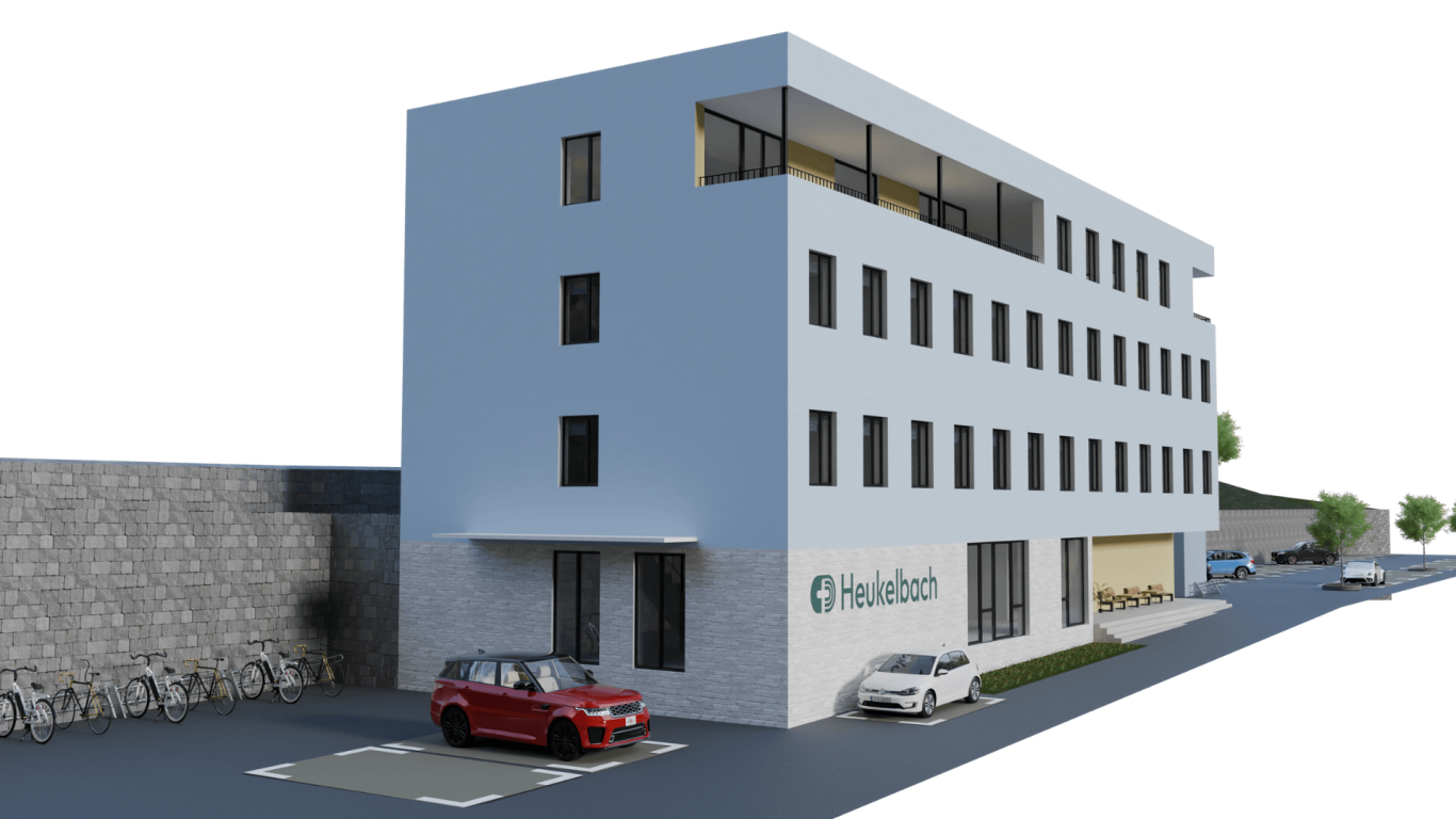 Bürogebäude - Stiftung Heukelbach Moderne Gebäude mit mehreren Etagen, rotem Auto und Parkplätzen.